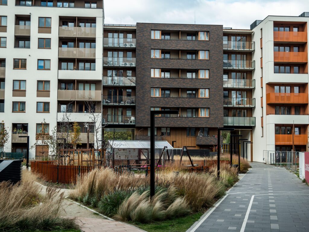 Contemporary apartment buildings with a small playground area in front.