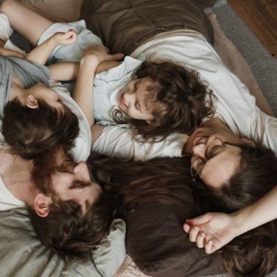 pexels-photo-6338442-6338442 A happy family lying on the floor, enjoying precious bonding moments indoors.